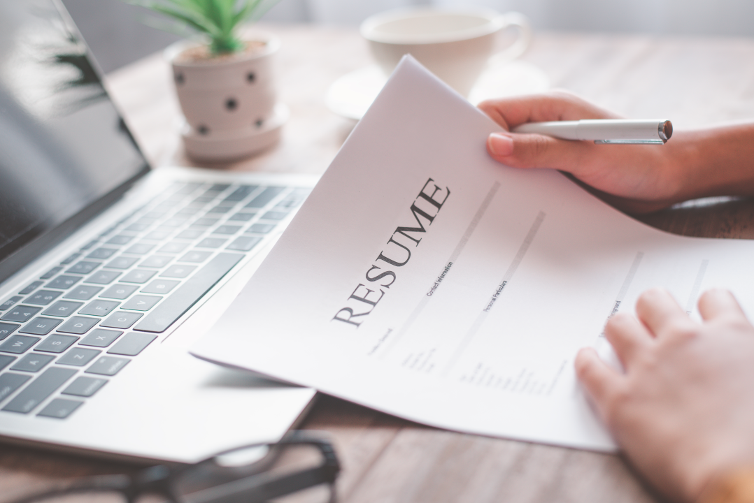 A CV being filtered through automated screening before reaching a human reviewer.
